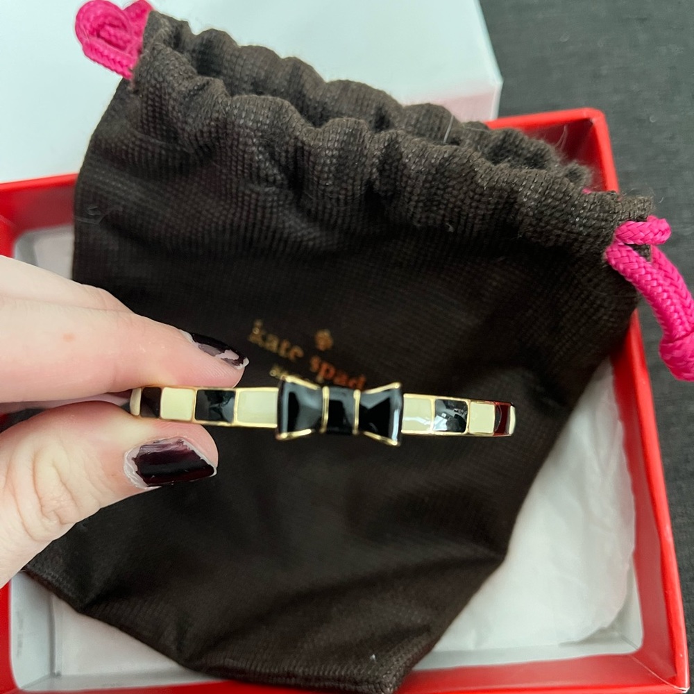 Kate Spade black and gold bow bracelet.